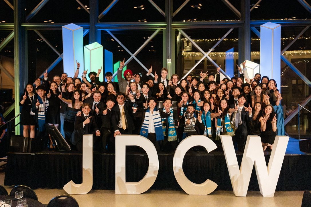 The UBC Sauder delegation on stage with the JDC West trophy
