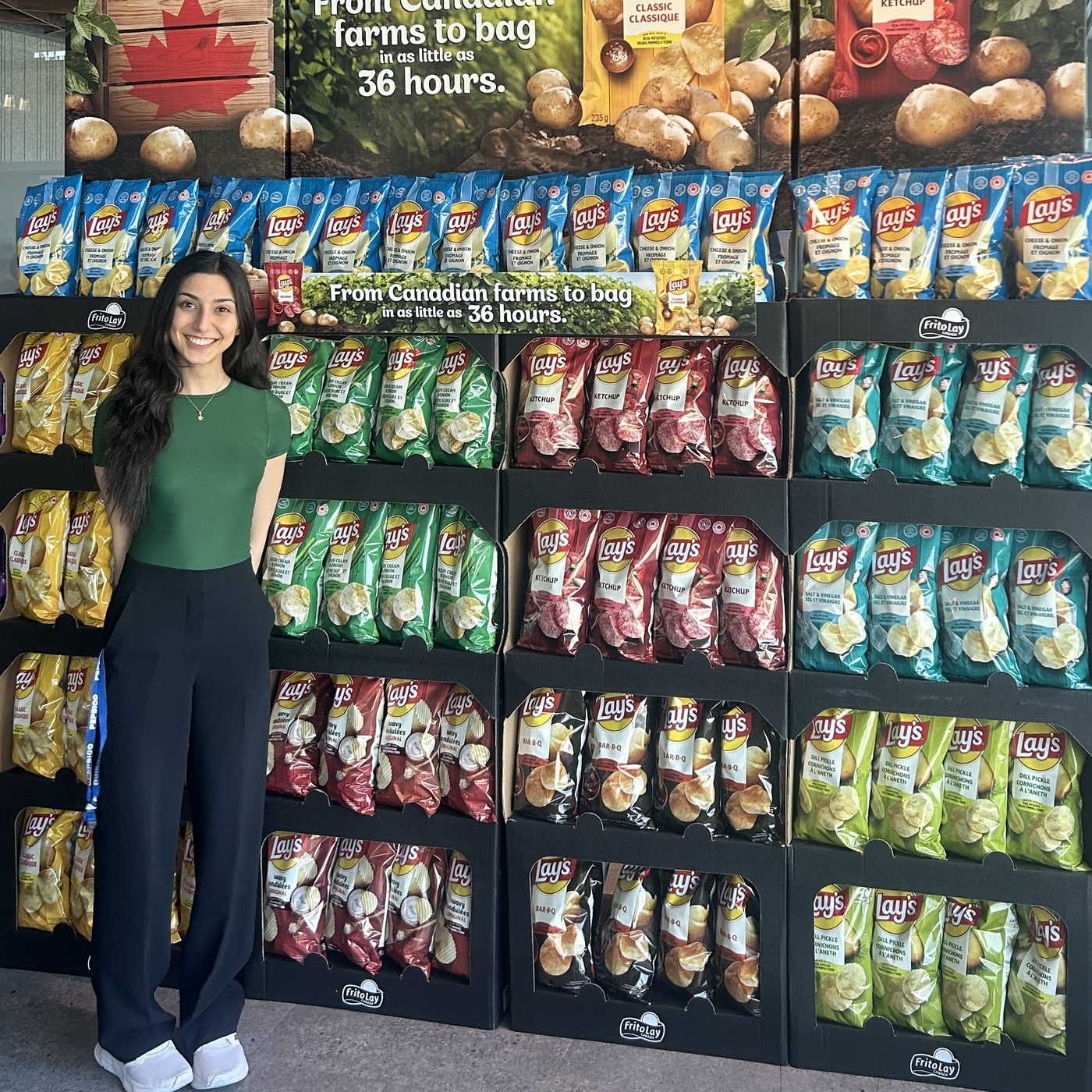Irene standing beside a large Lay's in-store display unit